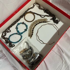 Tray of jewelry with missing parts and a bag of parts
